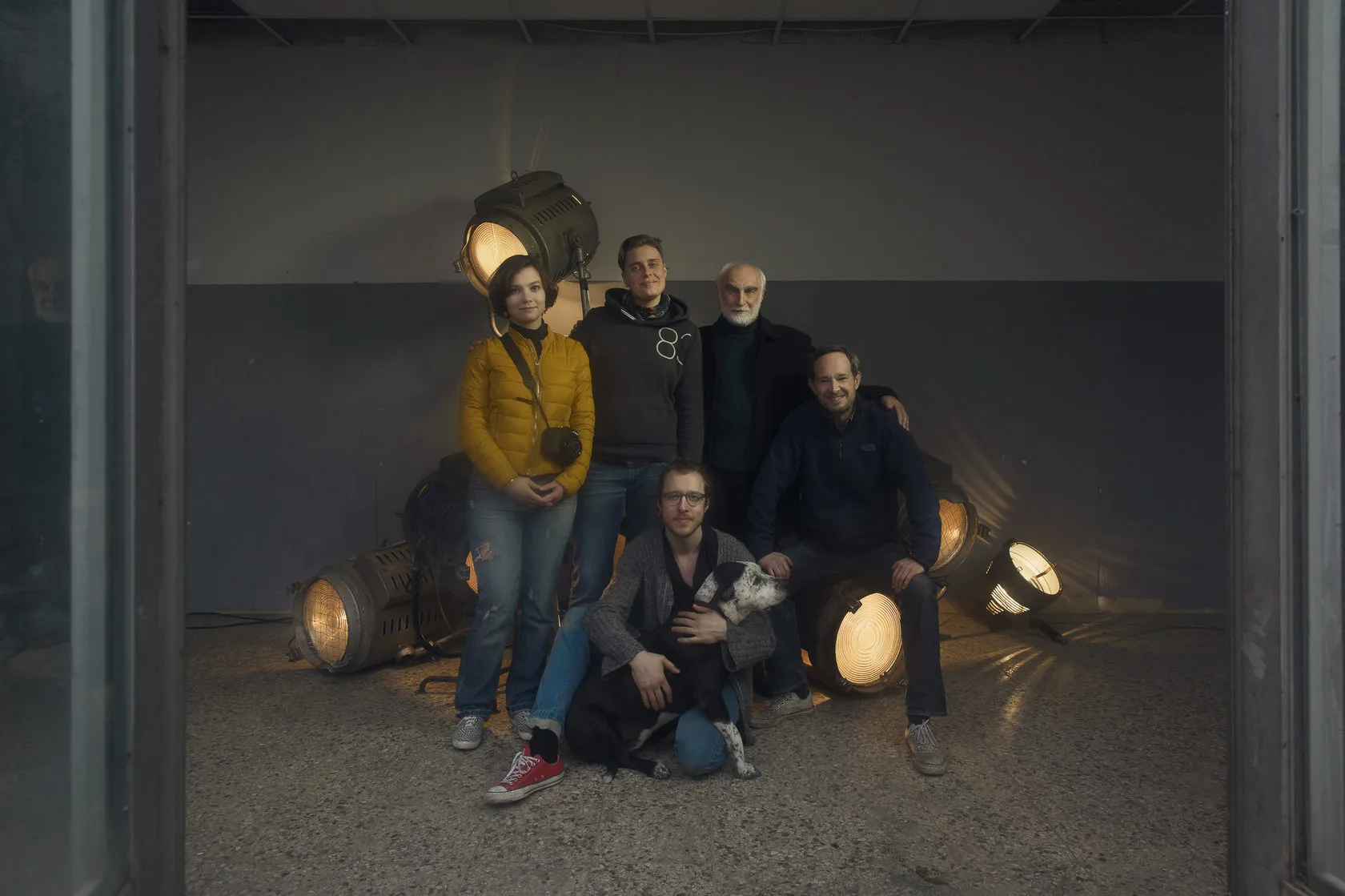 The crew and Batoni Merab, with a dog, among the glowing studio lamps.