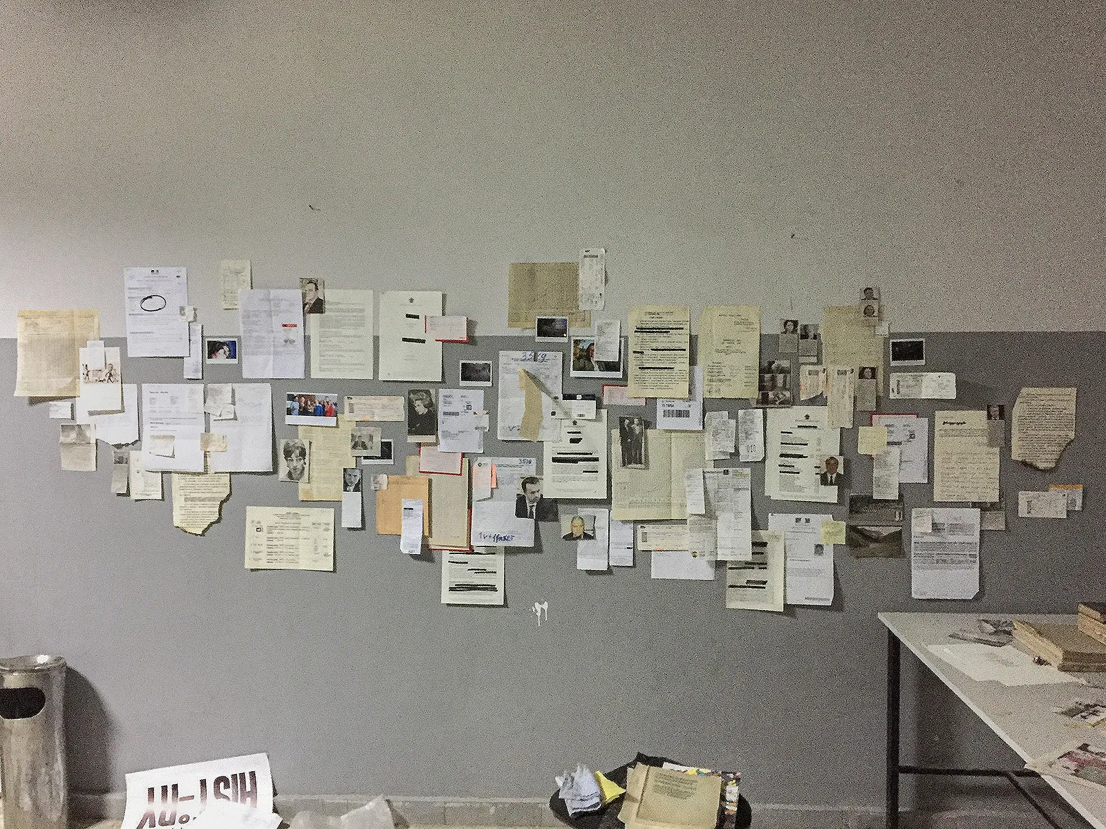 A wall pinned with dozens of papers and photos on the first evening of the build.