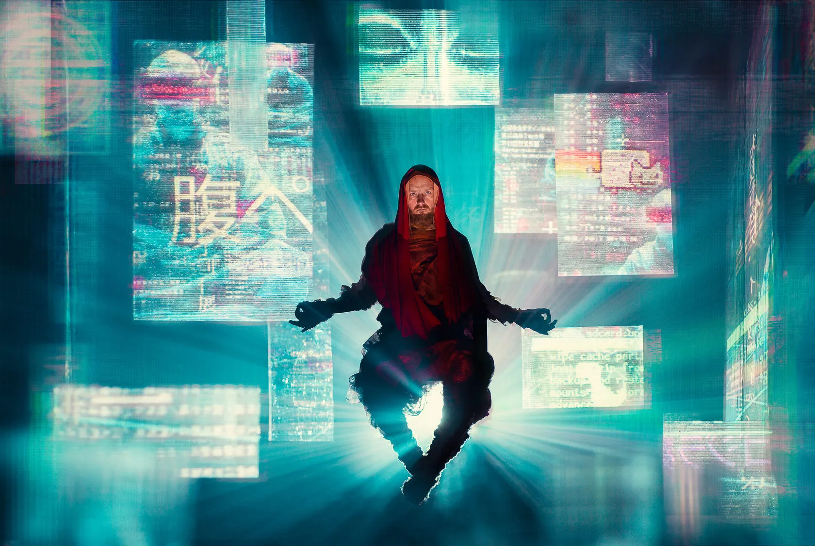 The Cyber Monk hovers cross-legged in a burst of light among glowing screens.