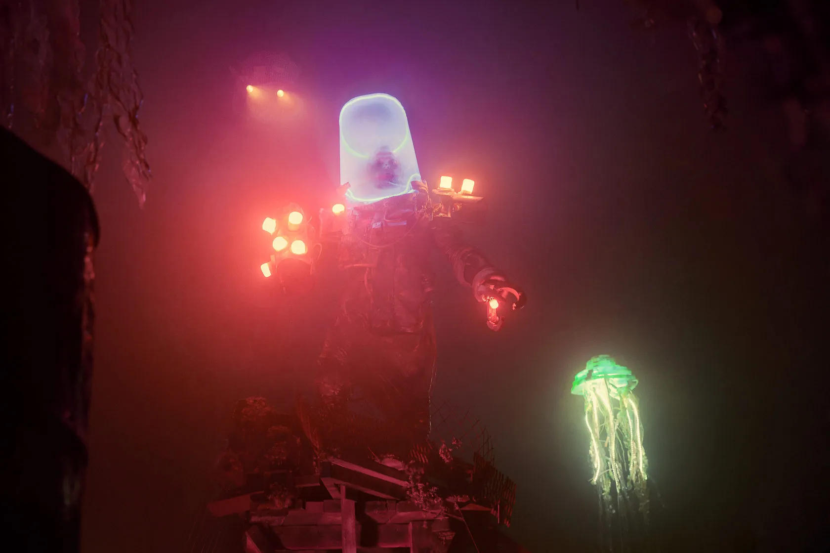 The Deepwater Treasure Hunter in a glowing diving helmet stands in red haze beside a neon jellyfish.