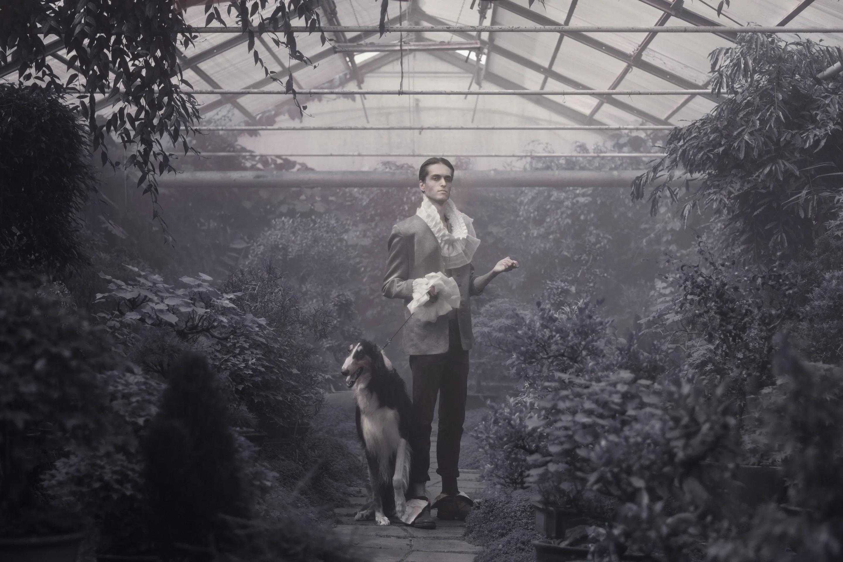 Photoband 2017 by Andrei Kovalev: a man in a ruffled Edwardian collar stands with a dog in a greenhouse.