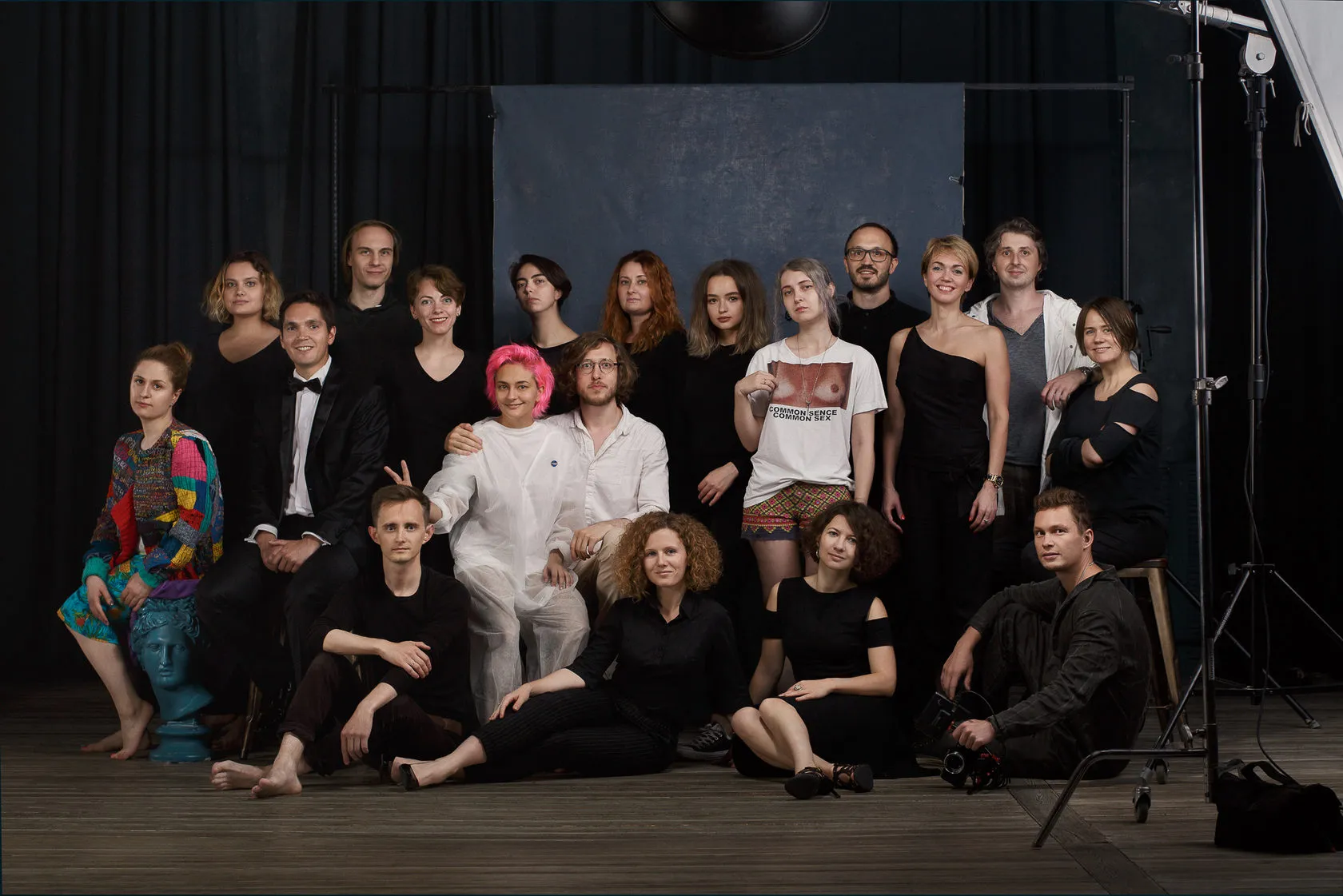 The course students and crew in a group portrait on a dark studio set.
