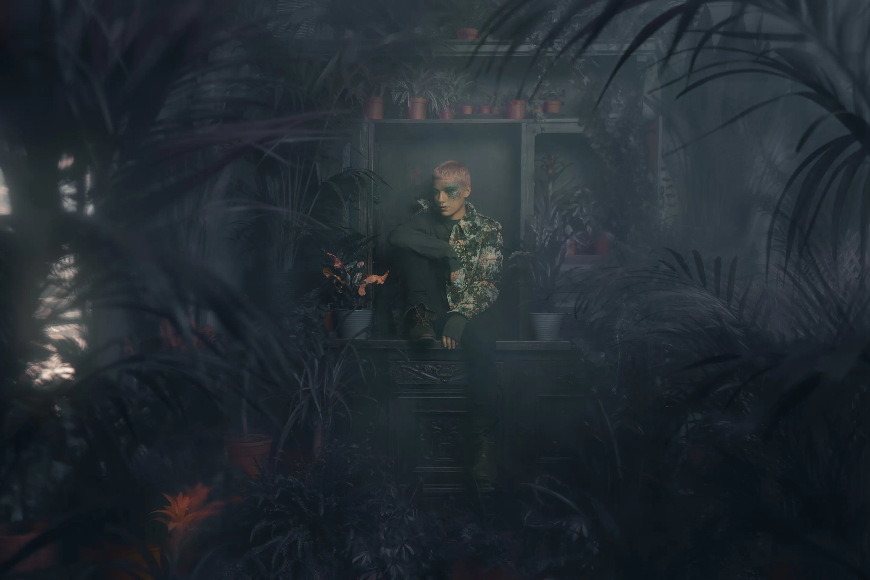 Fashion portfolio by Andrei Kovalev: a figure stands in a lit window within a dense, dark studio garden.