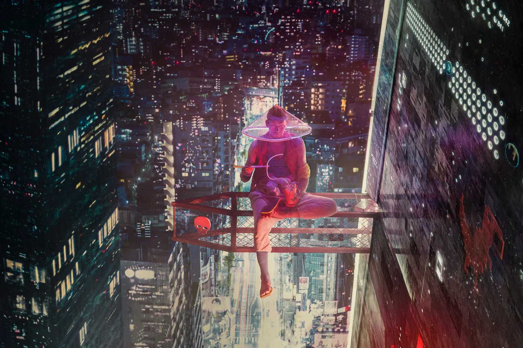 A man in a glowing conical hat sits on a metal ledge high above a neon city at night.