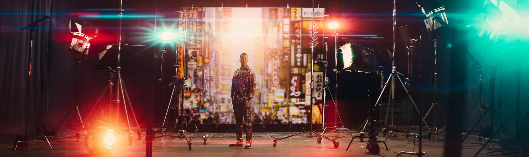 The inside front cover: a man stands in a studio lit by red and green lights and lens flares.