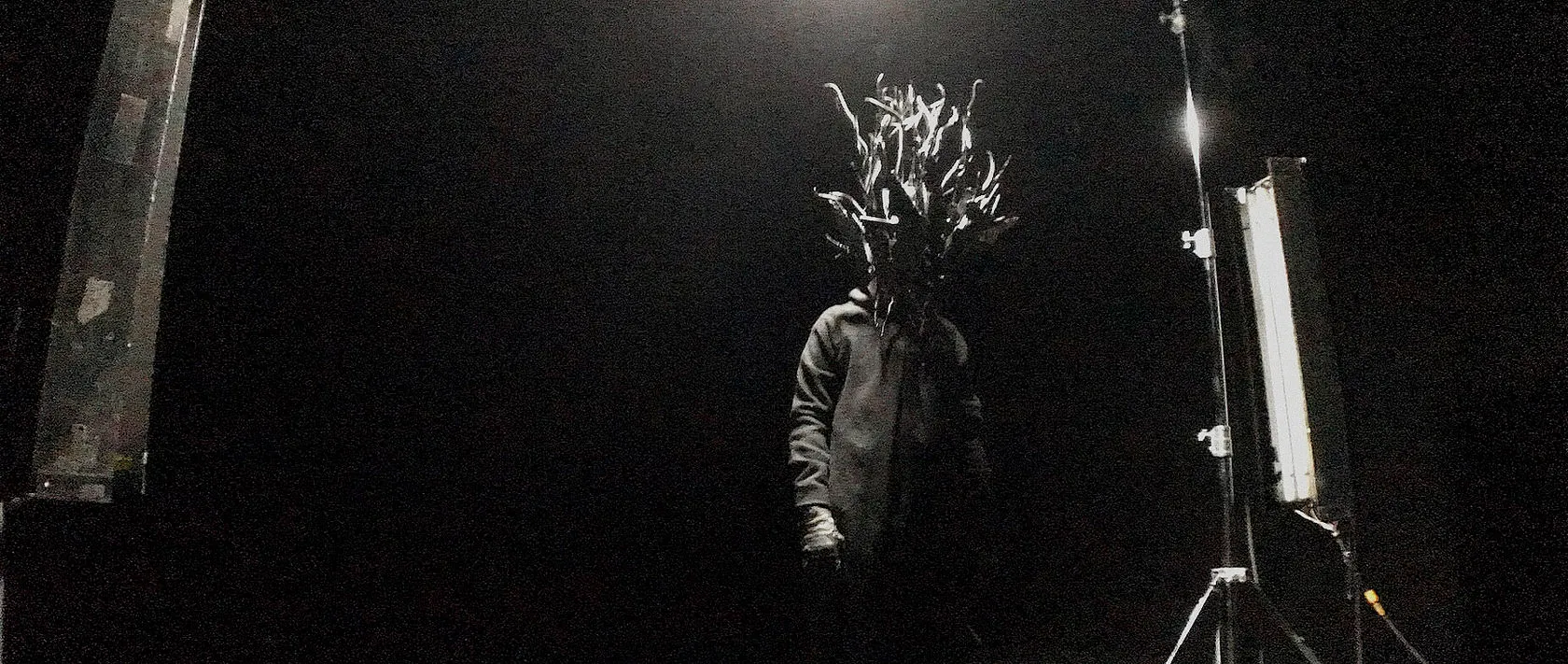 Chaos Reigns by Andrei Kovalev: Oleg Paschenko as Chaos, in a spiky foil mask, on a dimly lit film set.
