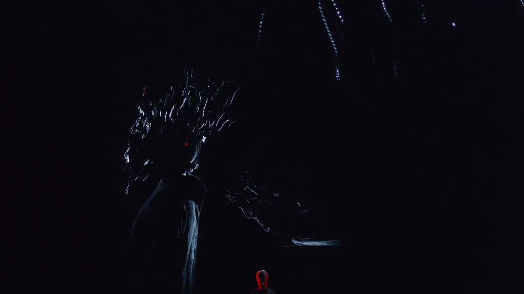 The Chaos mask, barely visible in the dark, with one red glint.