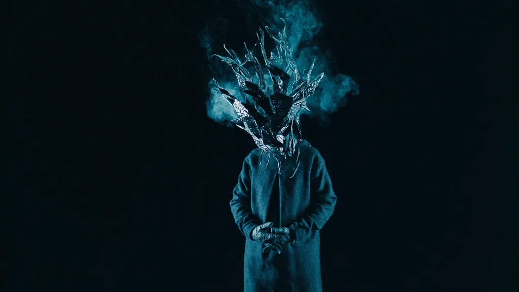Smoke rises from the Chaos mask above the figure in a blue coat.