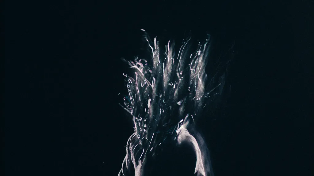 The mask blurs into white streaks of movement above bare shoulders.