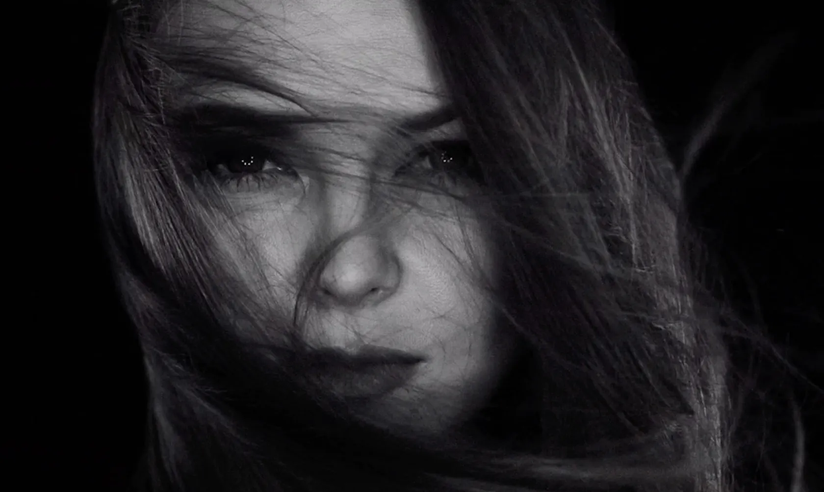 Music portfolio by Andrei Kovalev: a close-up portrait shows a woman's face partly hidden by windblown hair.