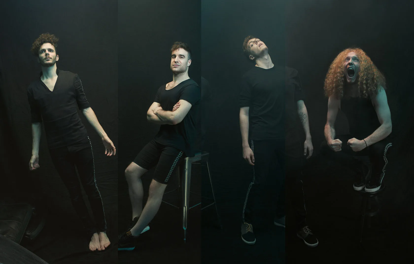The four members of Dot Legacy against a black backdrop, one with long red curls.