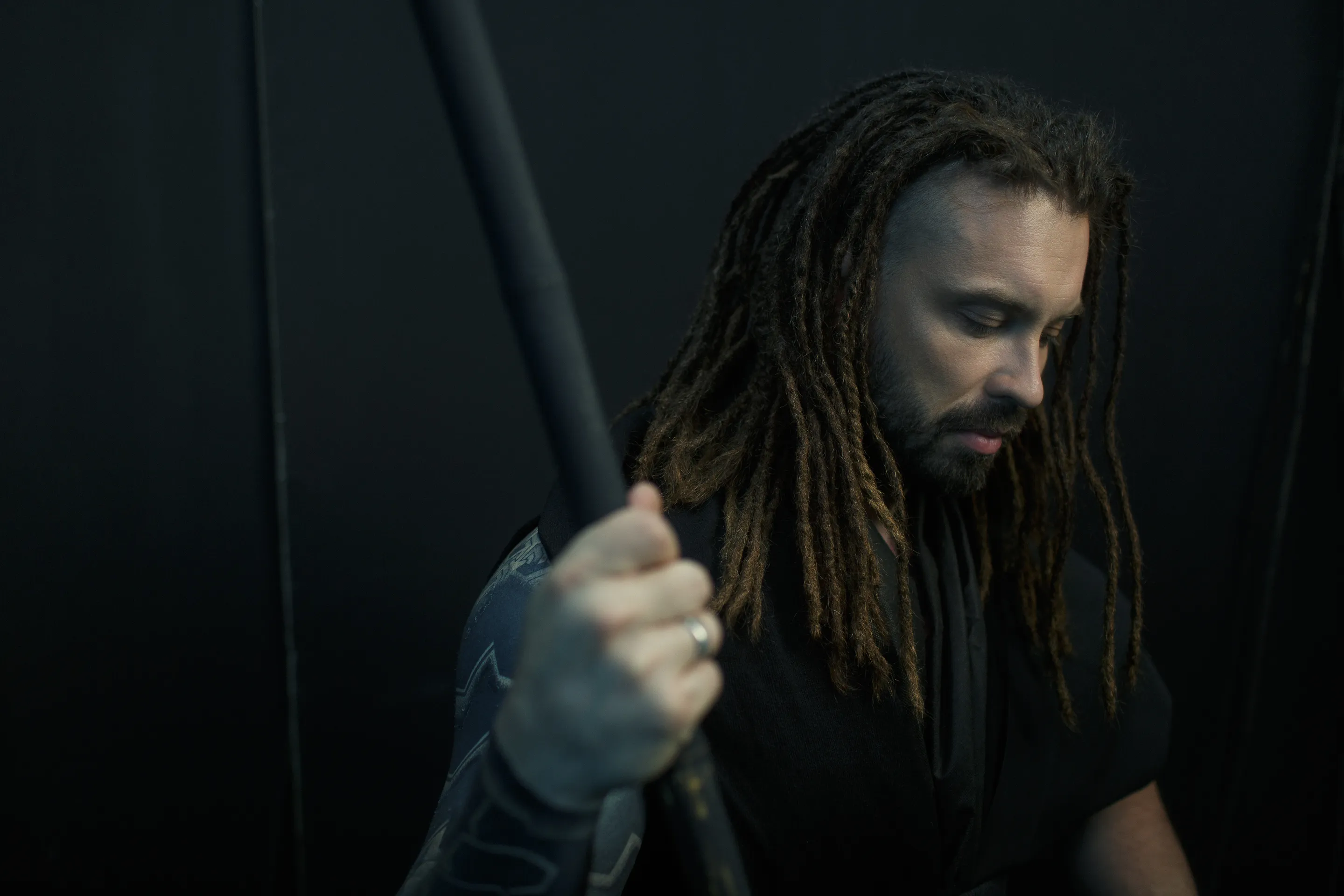 Burito album art by Andrei Kovalev: a dreadlocked man grips a vertical pole under dramatic light.
