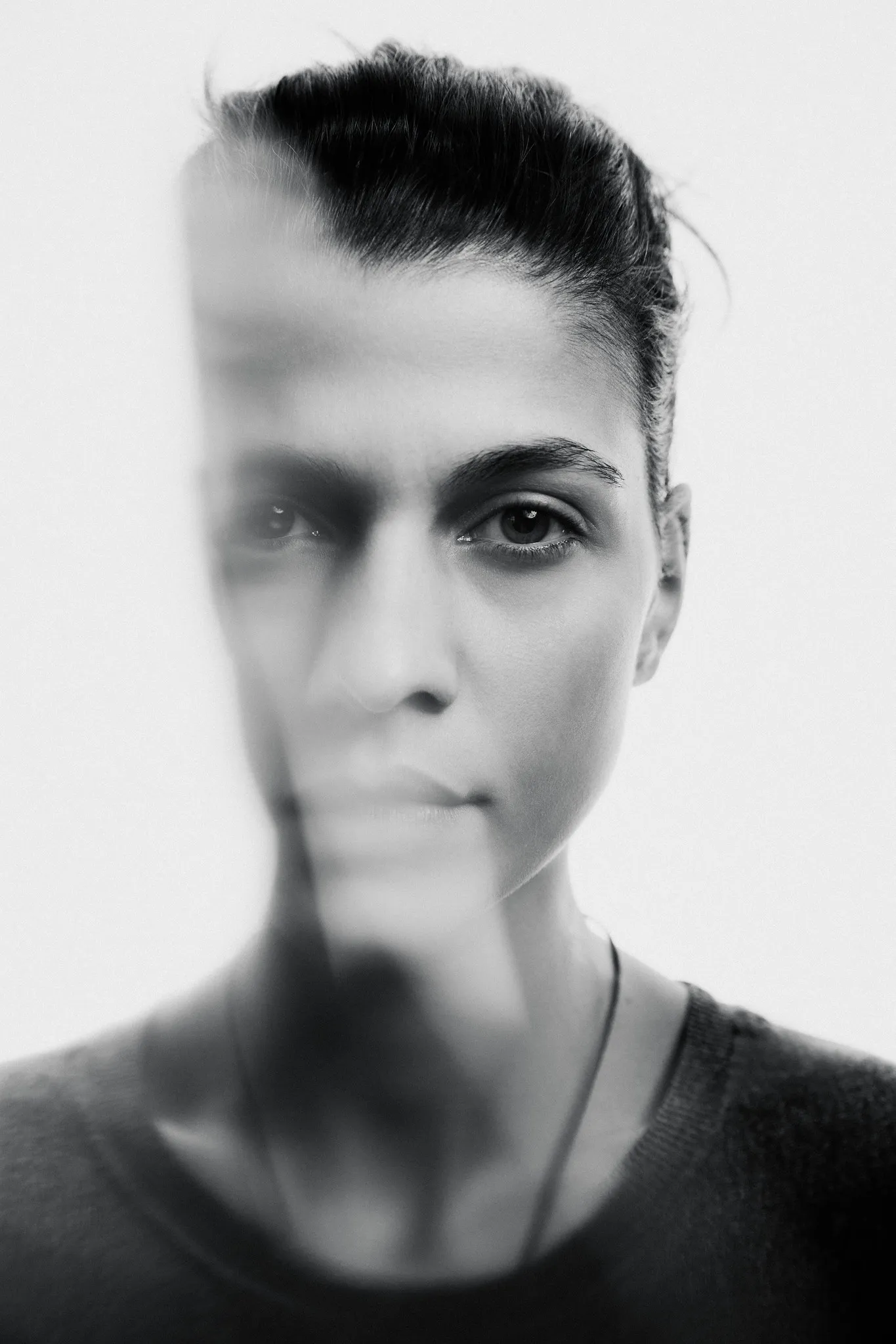 Nutsa Mestumrishvili in black and white, half her face blurred by movement.