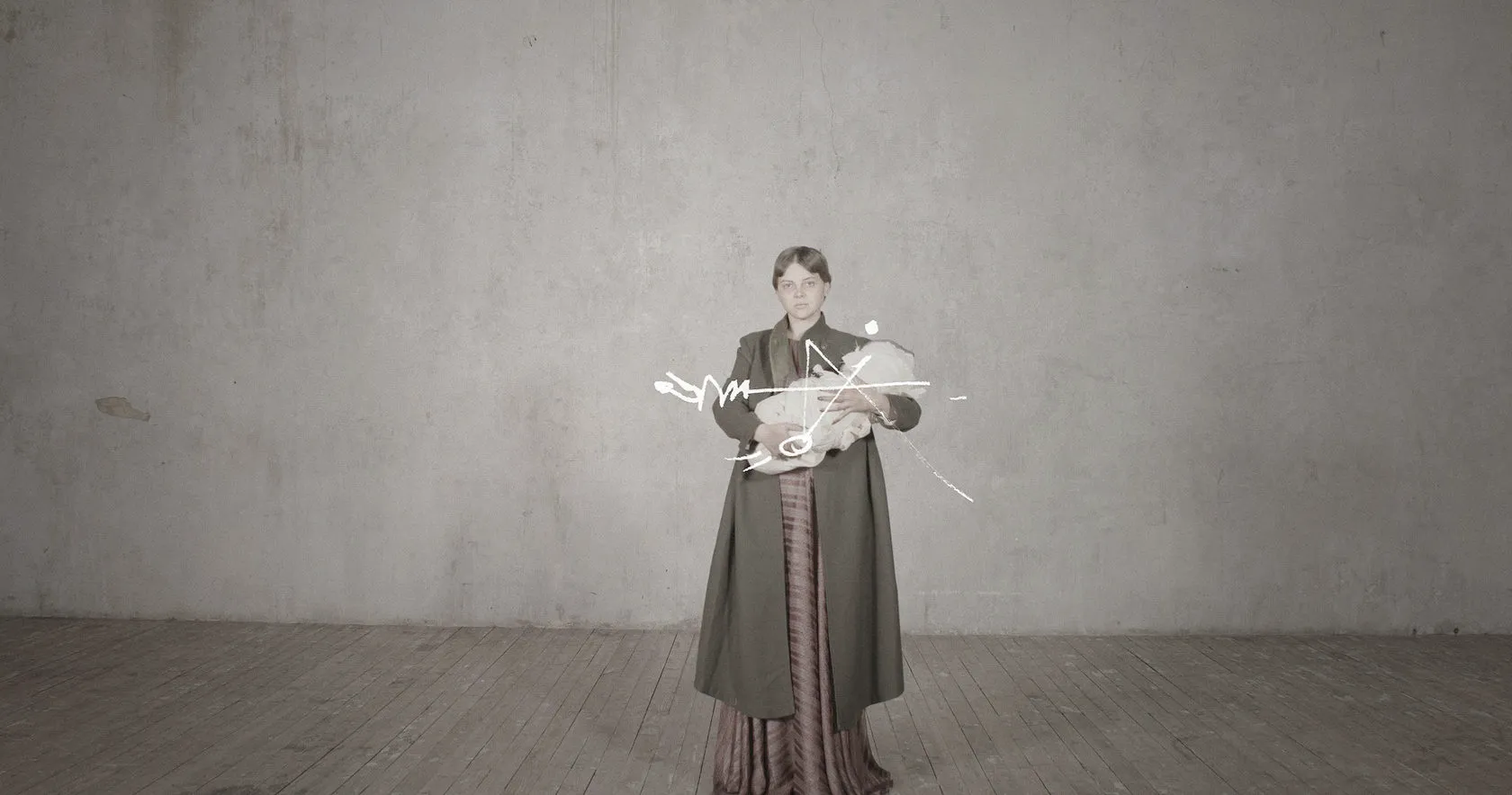 A woman in a long coat cradles a pale bundle, tangled in white scribbles.