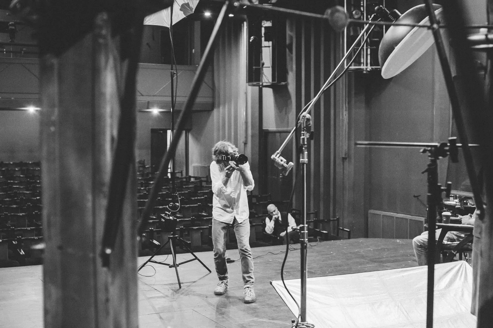 Behind the scenes: the photographer at work on the stage, seen from the wings.