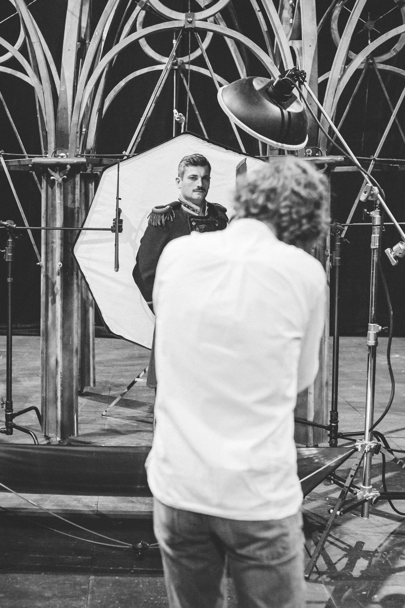 Behind the scenes: the photographer shoots an actor in a uniform jacket.