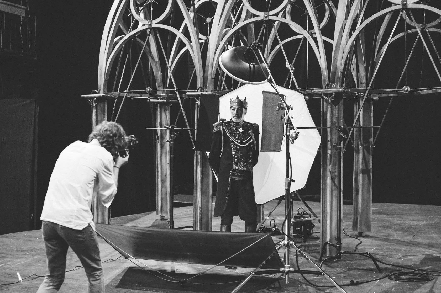 Behind the scenes: the photographer shoots King Lear in his crown under the Gothic arches.