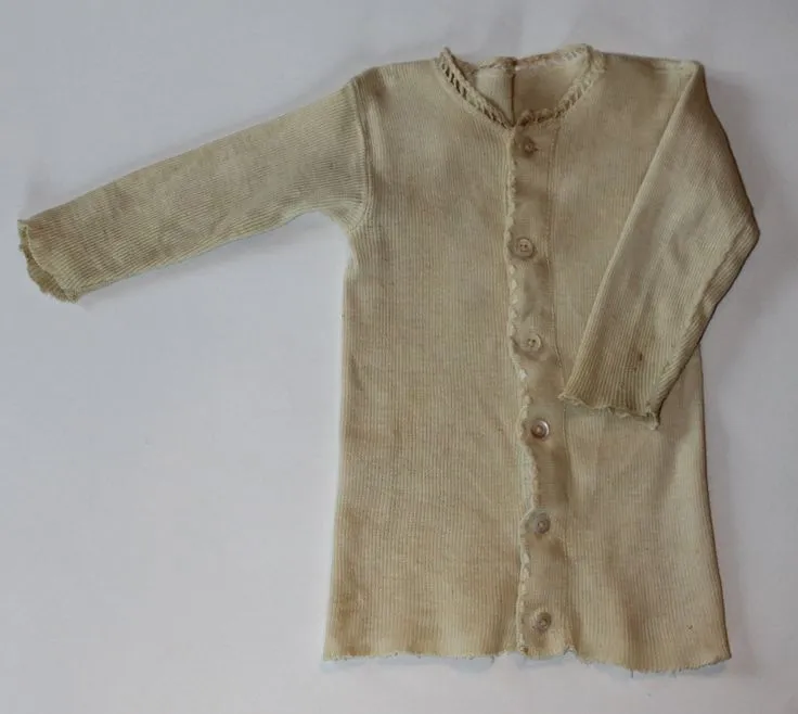 Reference: a worn, buttoned knitted undershirt.