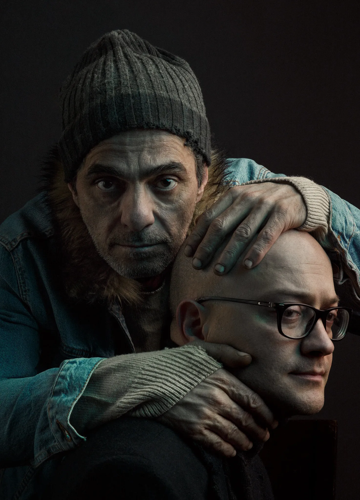 Test shot: the man in the knit cap holds the bald man’s head close.
