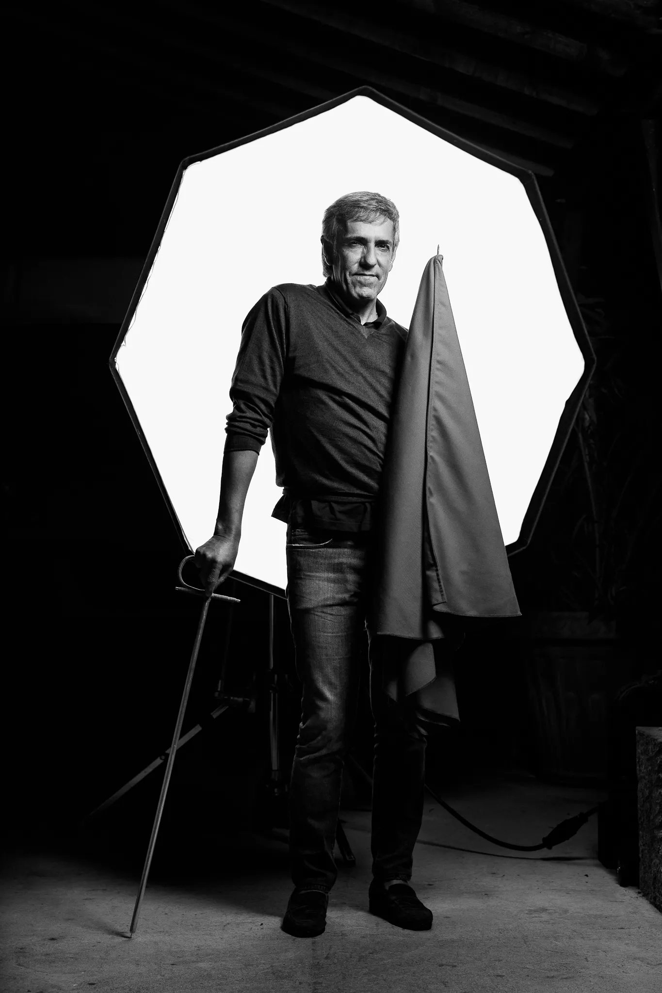 A winemaker from Emilio Moro stands before an octagonal light, holding a cane and a cloth.