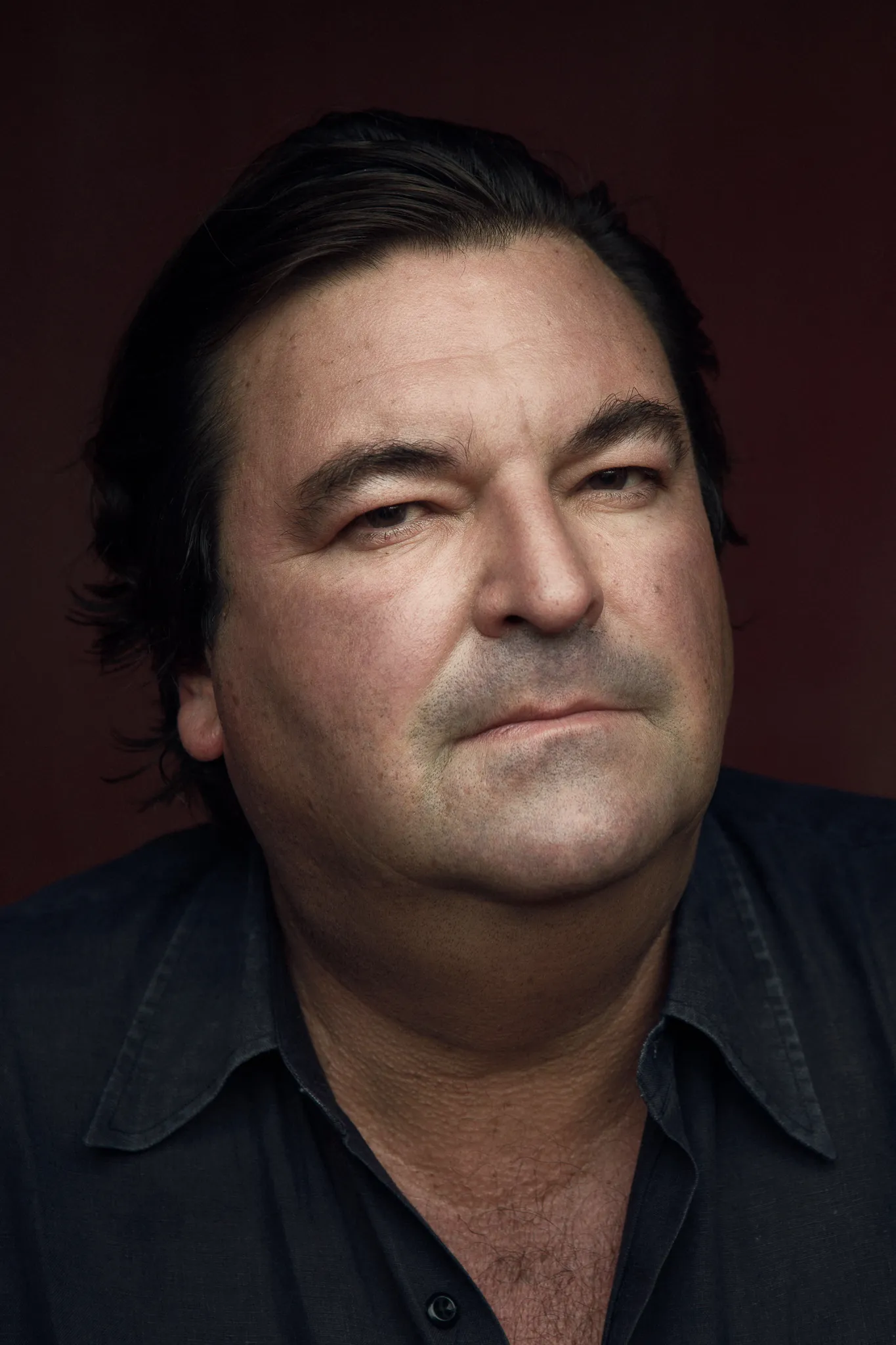 Sacha Alexis Lichine, close up against a dark red background.